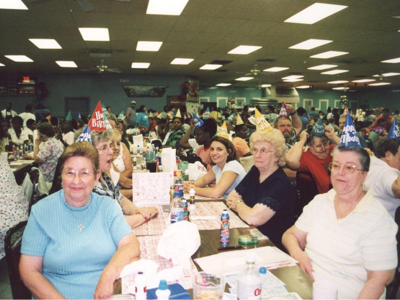 women gather around a table to play bingo