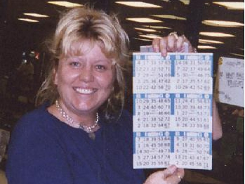 a women showing off bingo cards
