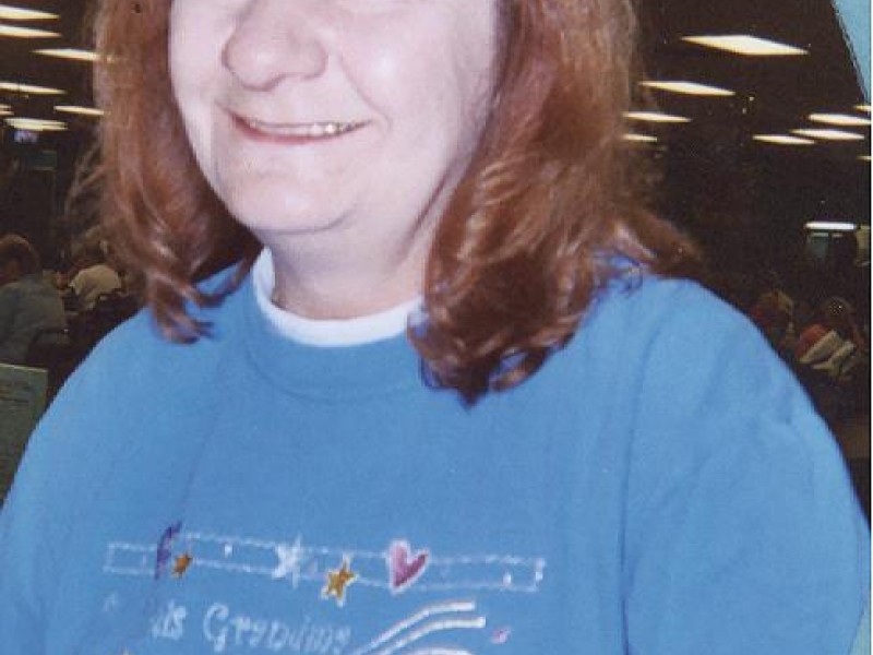 a women smiling with blue overlay