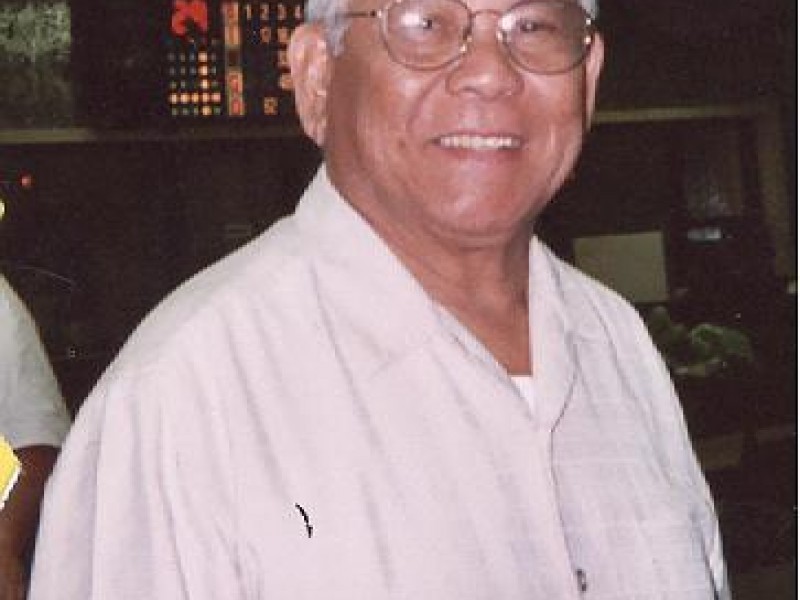 a man with glasses smiles at camera