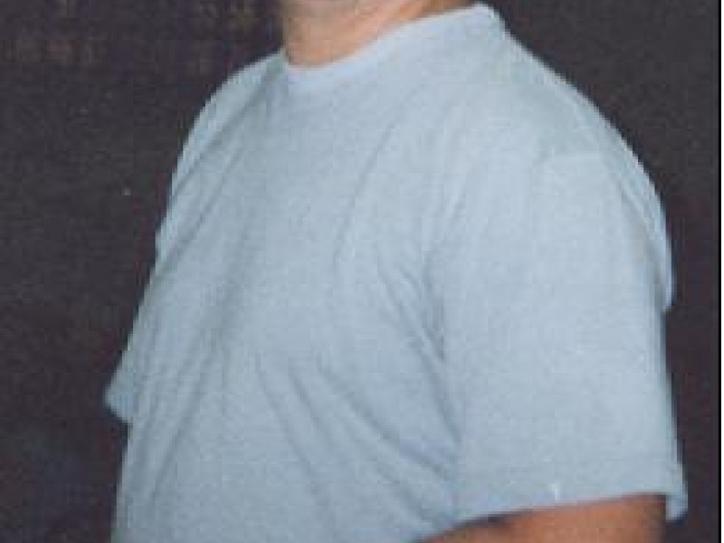 a man in grey shirt laughing 