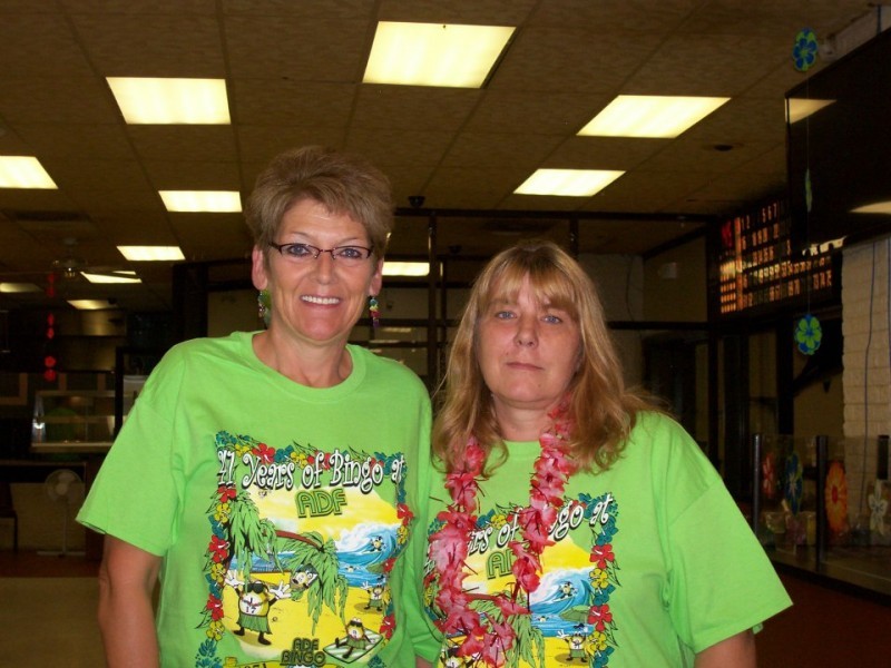 two women with green shirts