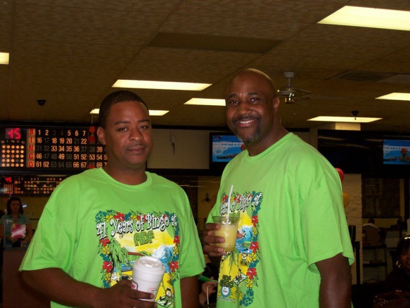 two men with green shirts
