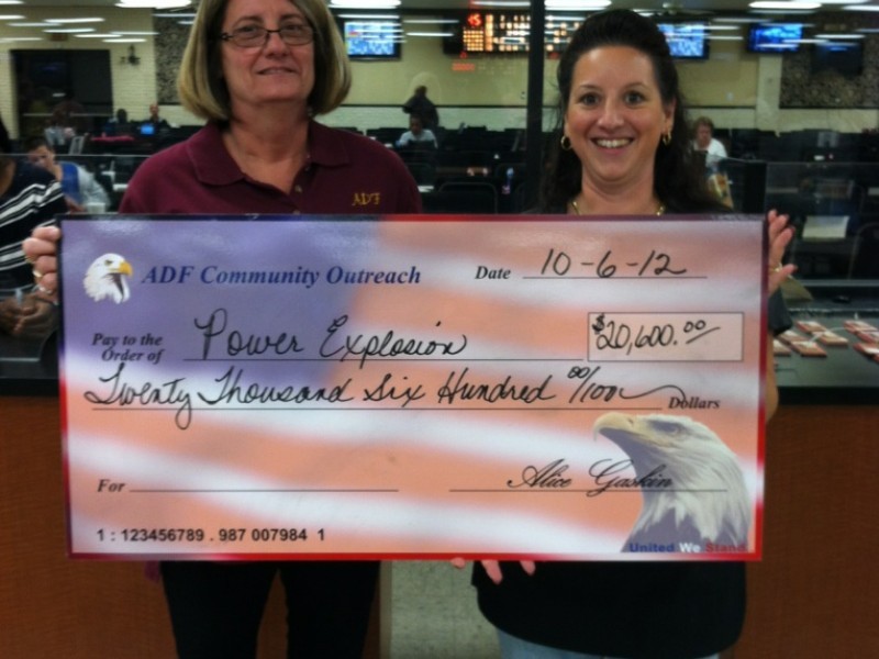 two women present an american flag check