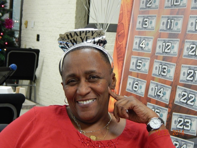 woman in happy new years tiara smiles