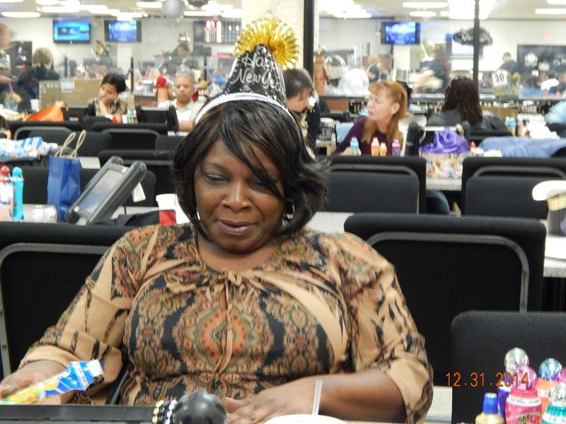 woman hunches back at bingo table