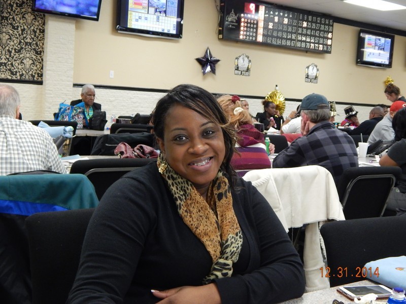 woman leans on a table at bingo