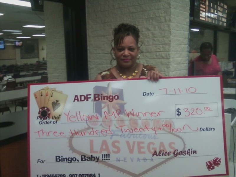 woman shows large bingo check