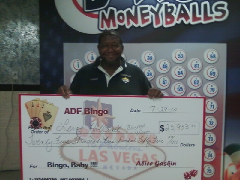 man shows off his giant bingo check