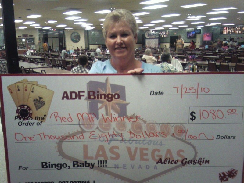 woman displays giant check for bingo