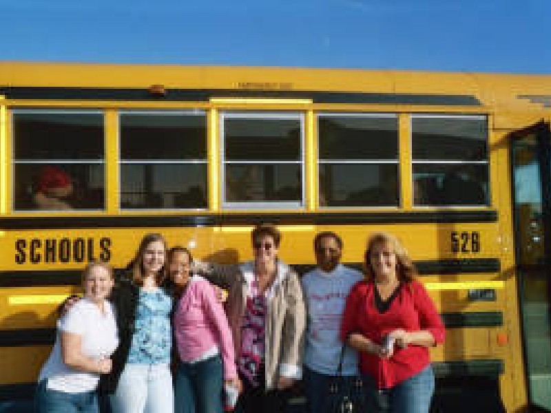 kids in front of a schoolbus