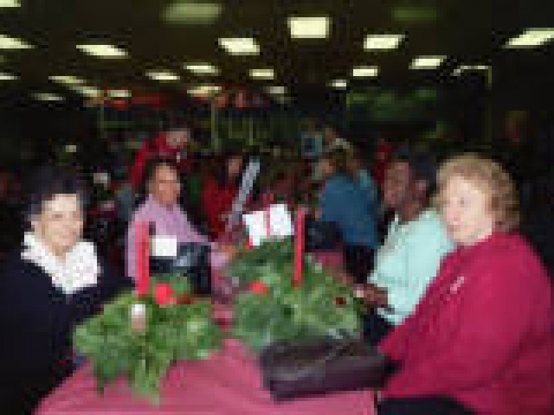 a long table of women with wreaths in the middle