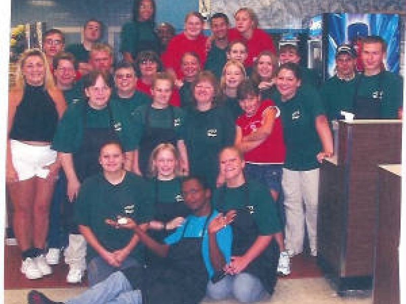 a group of gree shirted bingo hall employees 