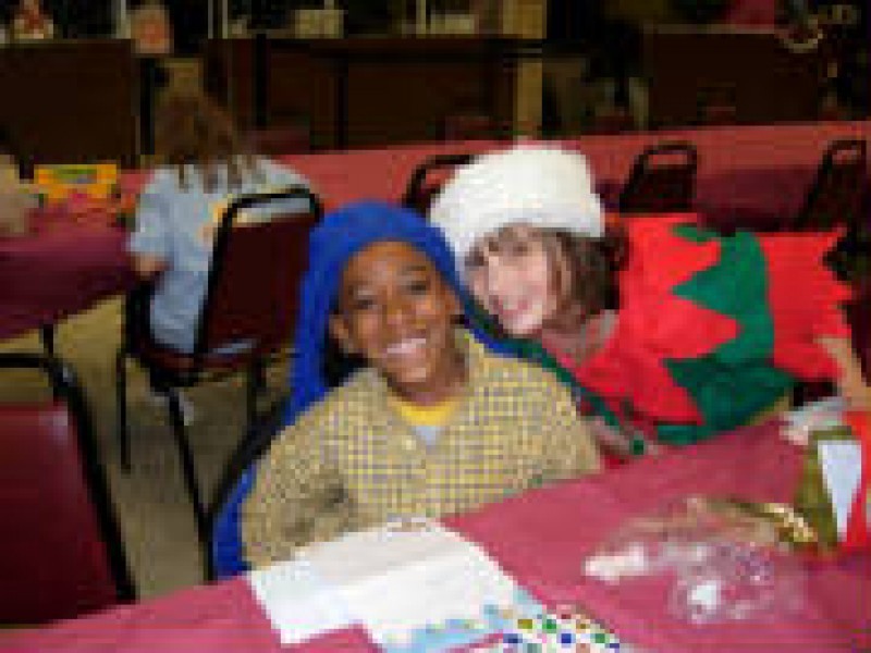 girl dressed as an elf and a boy in a blue hat