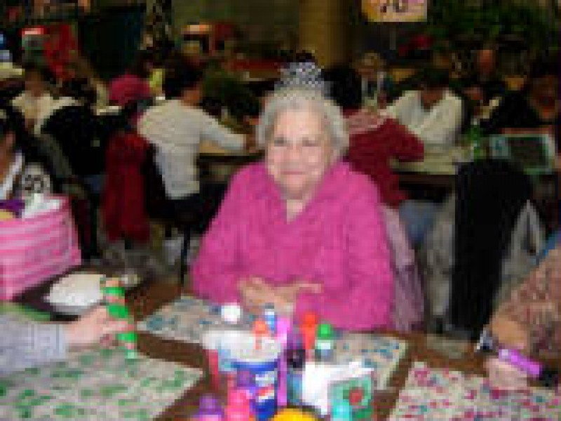 older woman in pink at bingo table