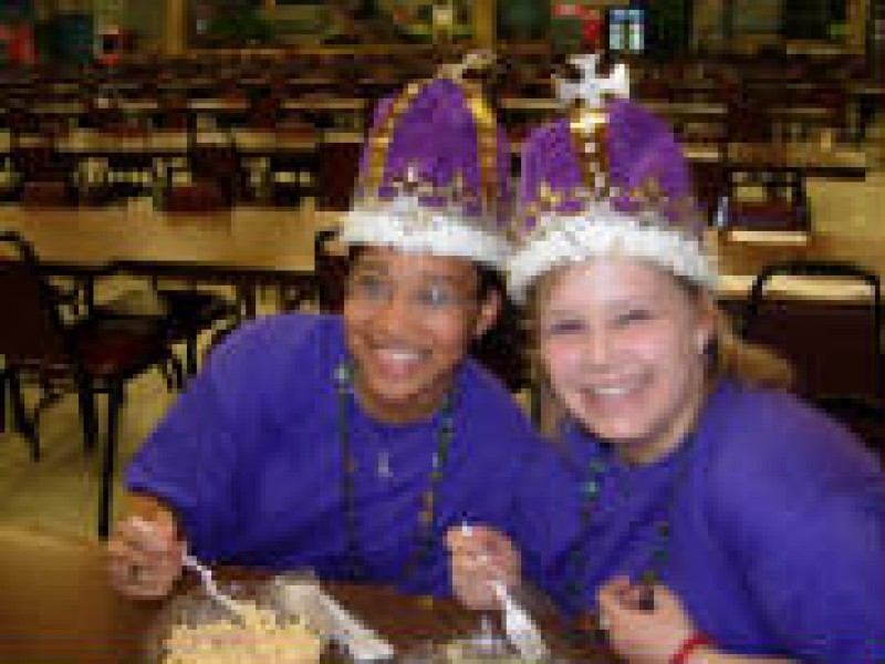 two people in purple in crowns