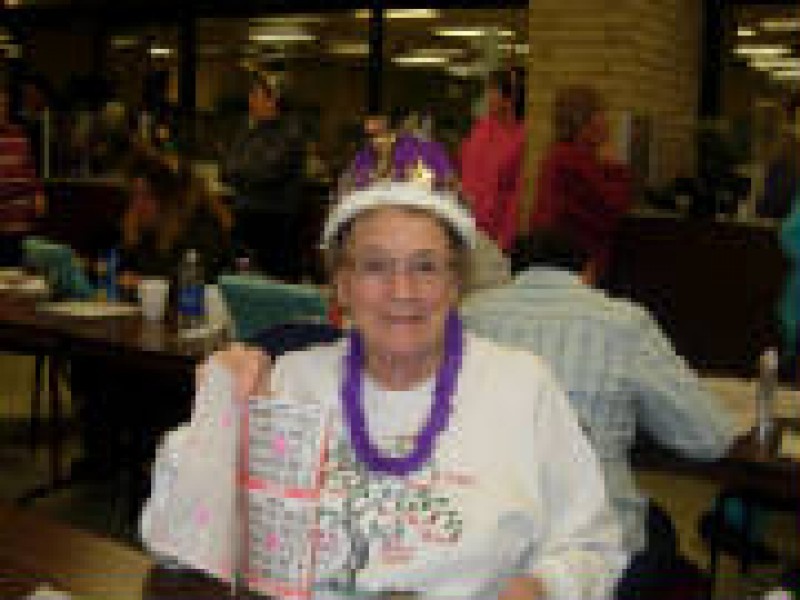 a woman in a purple queens crown