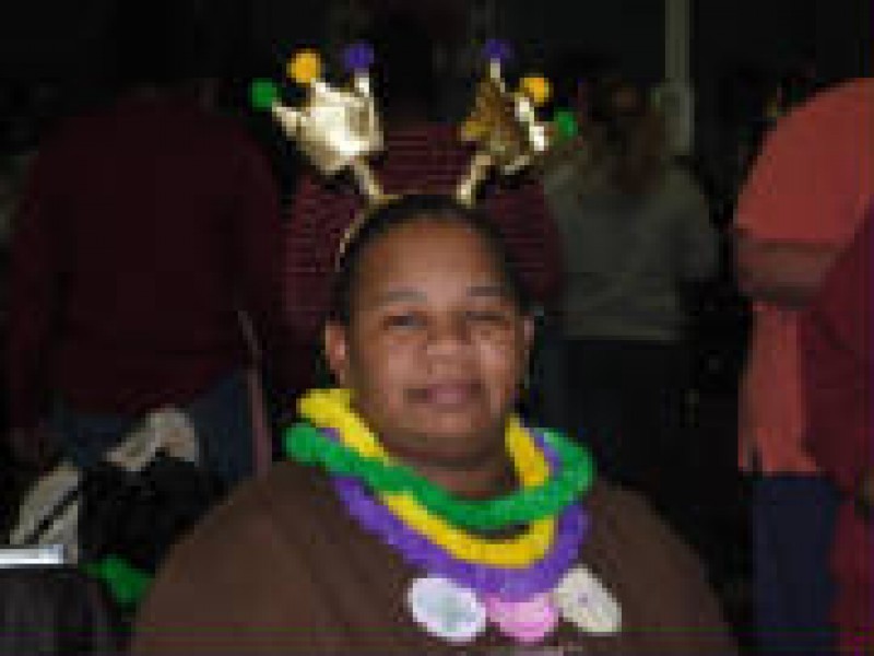 woman with fun headgear and leis 