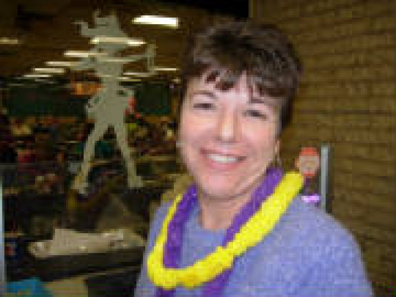 woman with yellow and purple leis