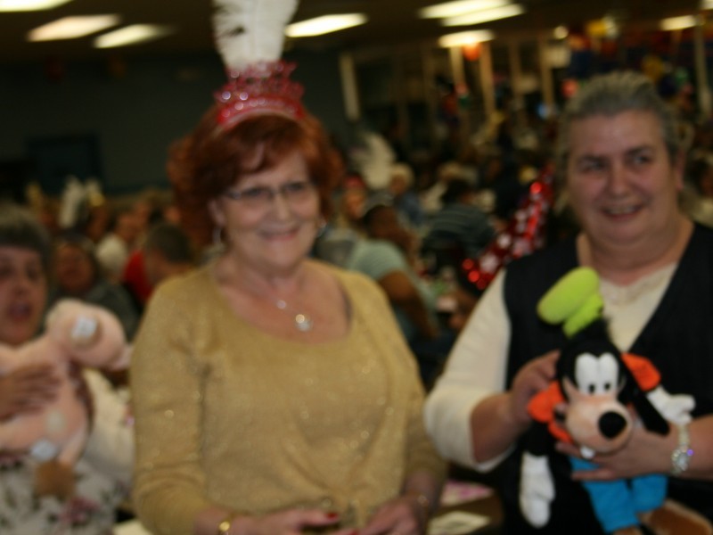 two women with stuffed goofy doll