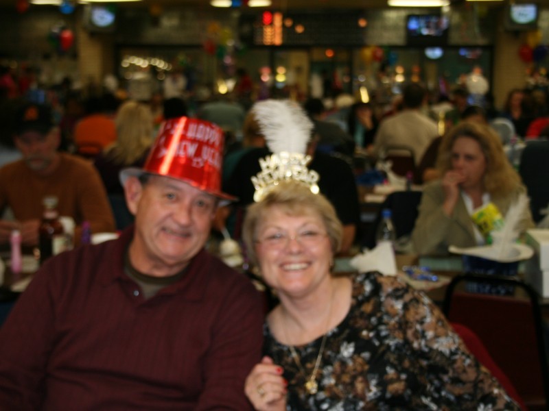 older couple wear hats at new years celebration 