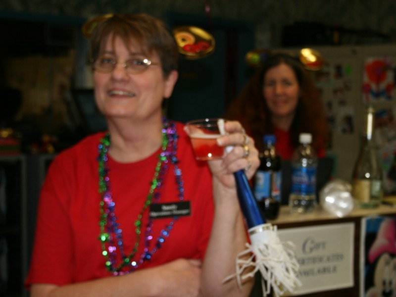 woman in red shirt wears a lei at new years celebration