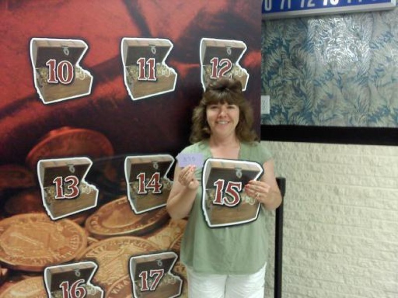 woman holds number 15 treasure chest