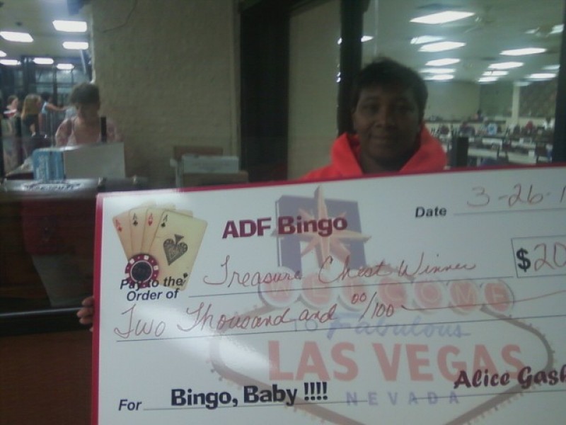woman with check prize at bingo
