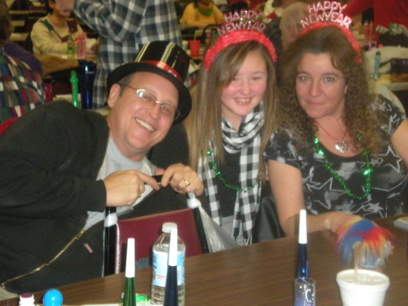 three people in happy new years headwear