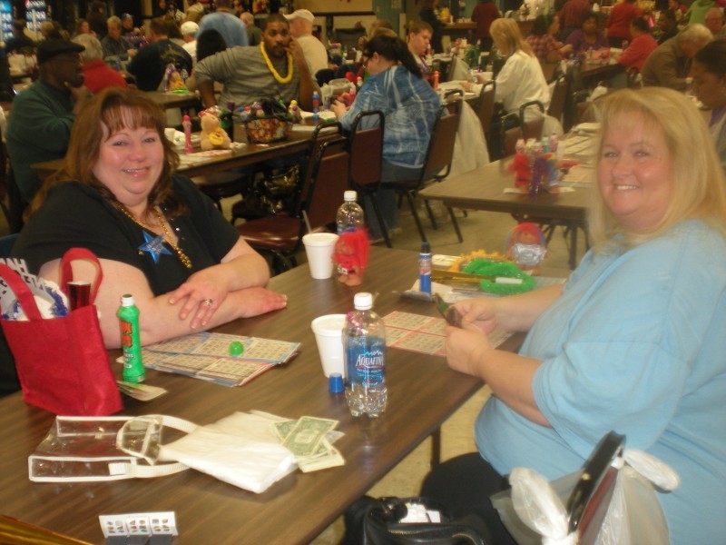 two women prepare to play a game of bingo