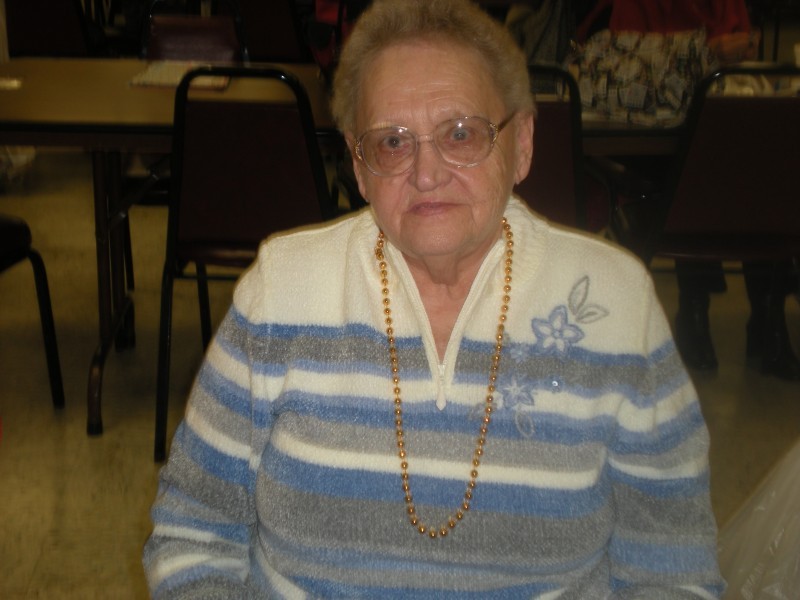 woman with glasses and gold beads