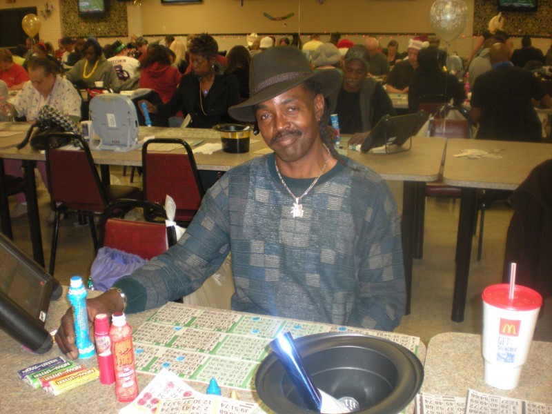man in brown hat with bingo cards