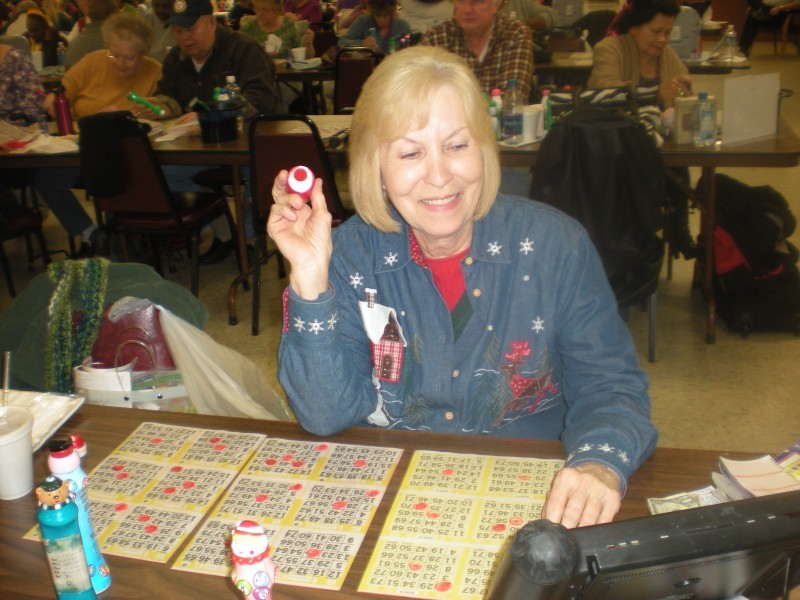 woman watches electronic bingo board