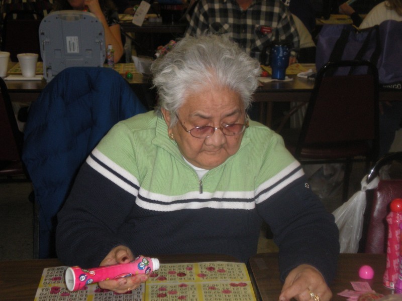 man watches his bingo cards