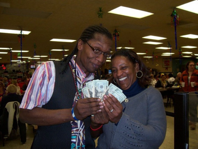 man and woman show off cash winnings
